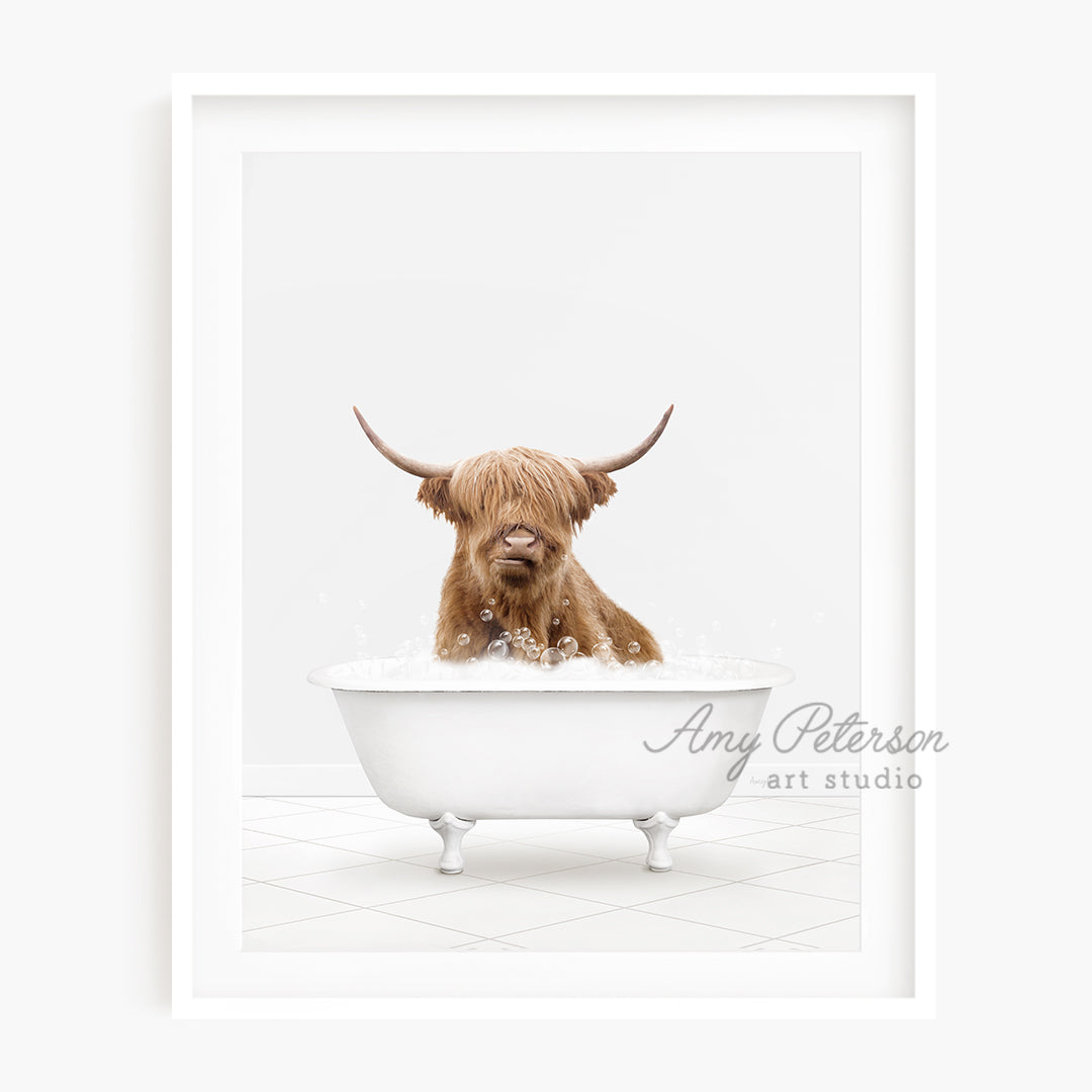 a brown dog sitting in a bathtub with long horns