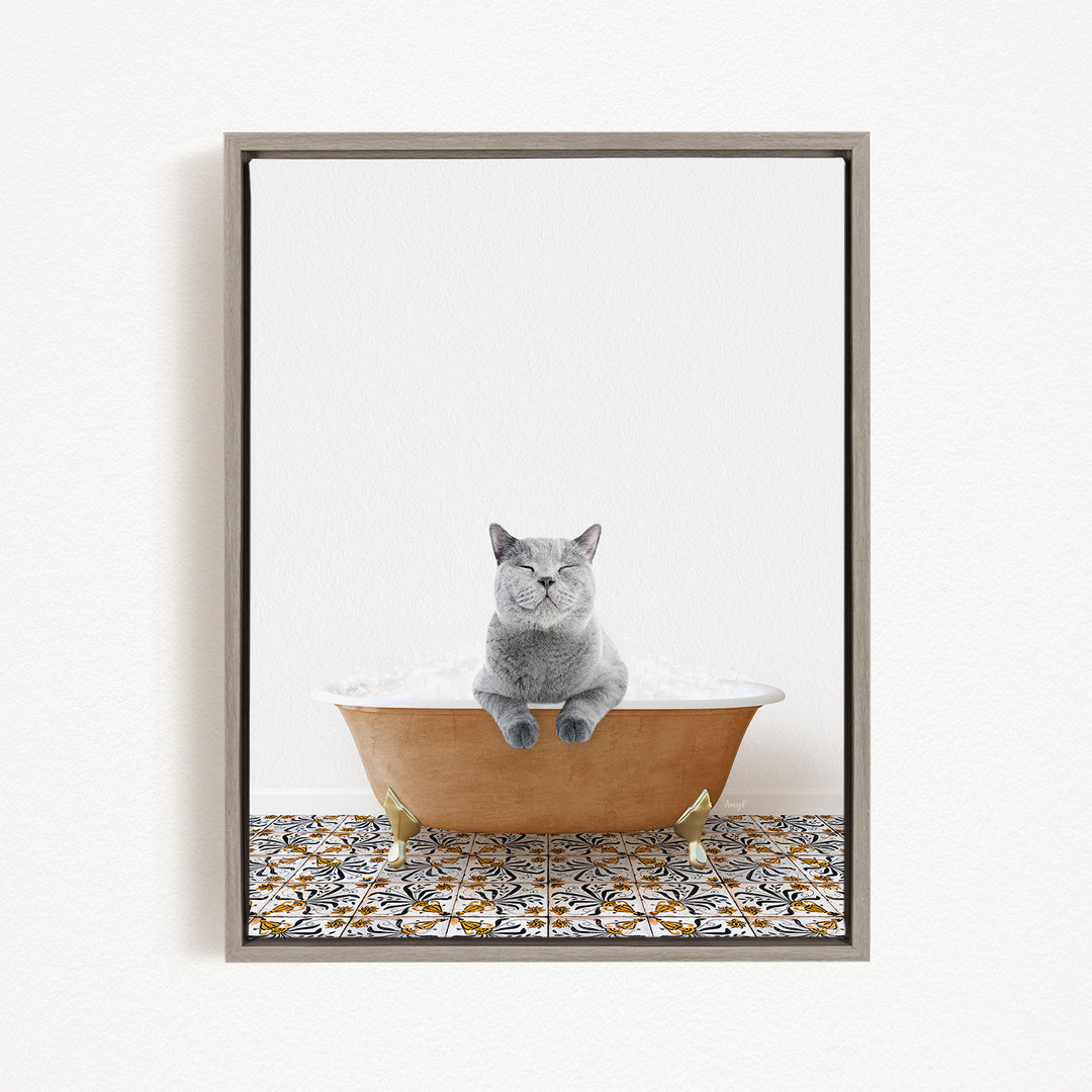 A gray cat sitting in a bathtub filled with bubbles, with a patterned tile floor beneath it.