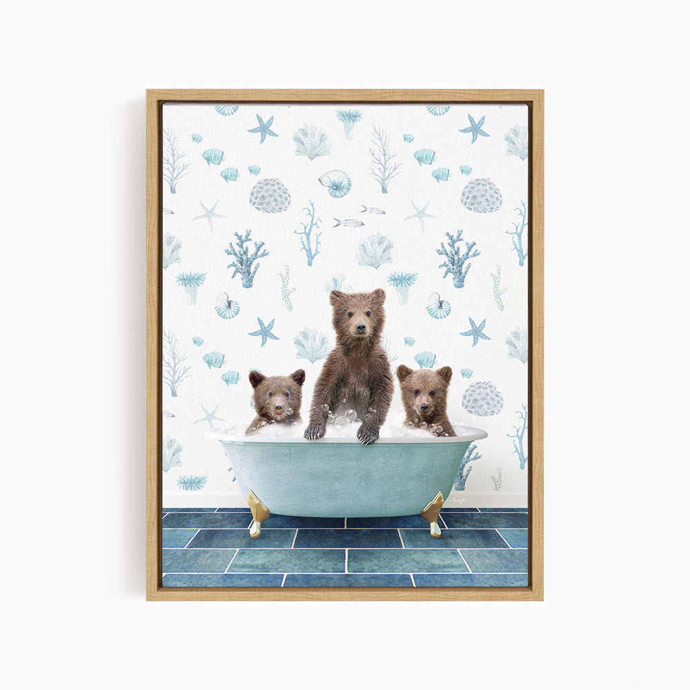 A framed print depicting three bears sitting in a bathtub filled with water, surrounded by a blue and white ocean-themed wallpaper.