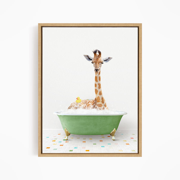 A giraffe is sitting in a green bathtub filled with bubbles, with a yellow rubber duck floating nearby.