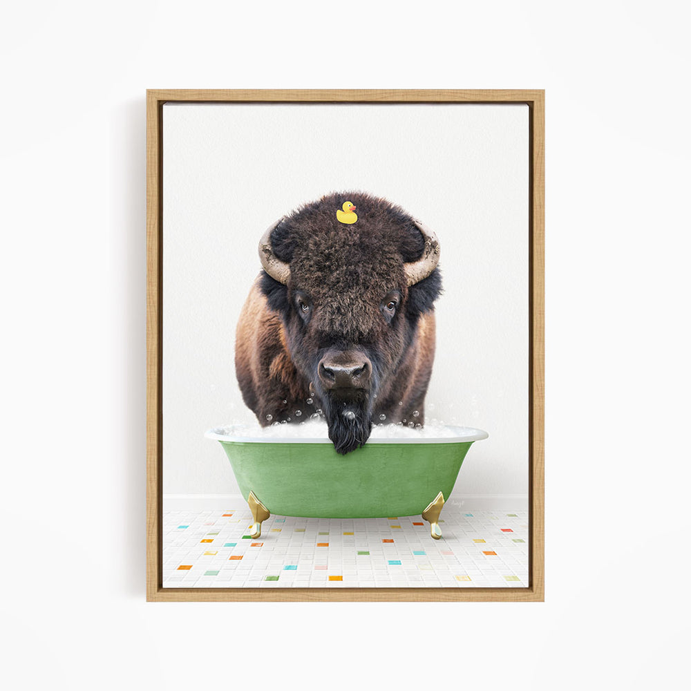 A buffalo with a yellow rubber duck sitting in a green bathtub.