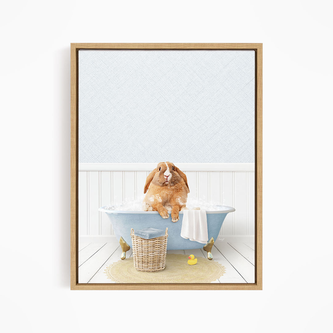 A brown rabbit sitting in a blue bathtub filled with bubbles, surrounded by rubber ducks and a basket.