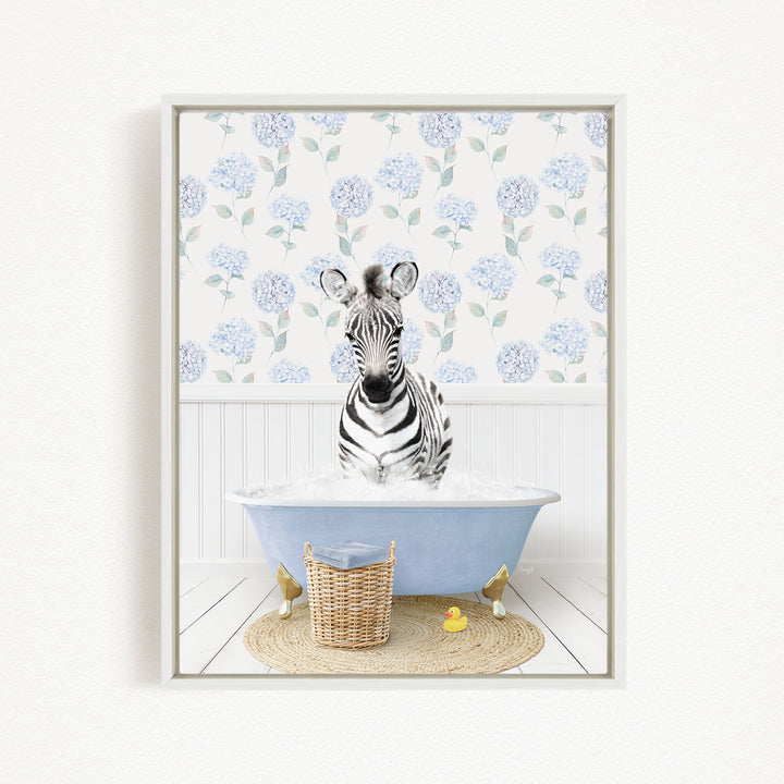 A zebra standing in a blue bathtub filled with water, surrounded by a wicker basket and a yellow rubber duck.