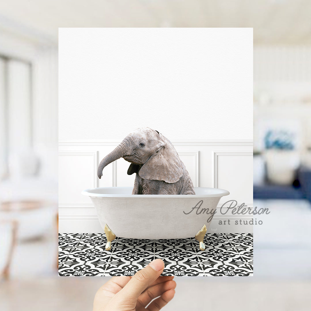 a person holding up a picture of an elephant in a bathtub