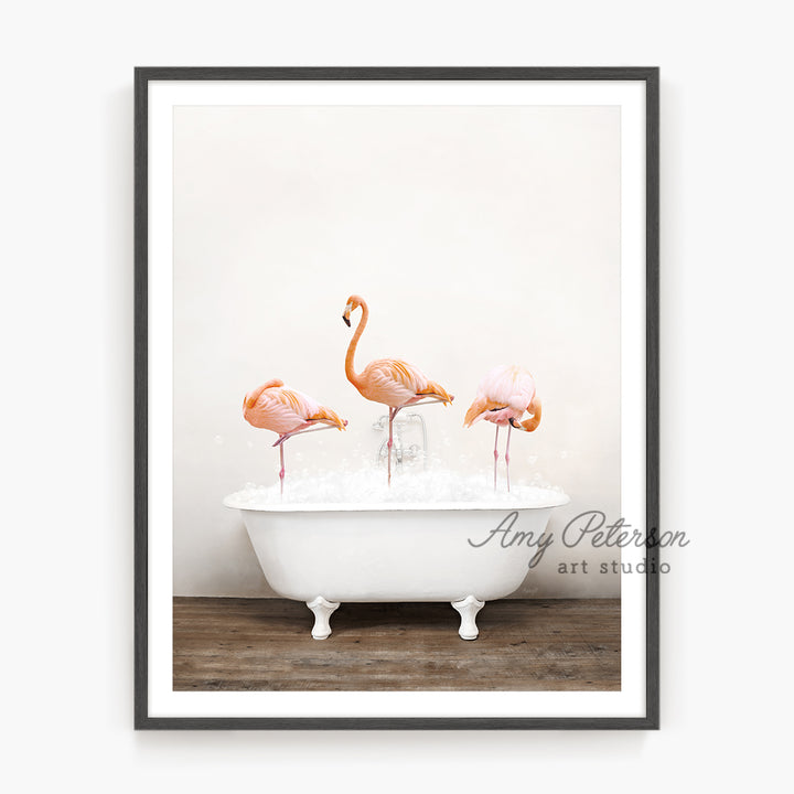 three flamingos in a bathtub with water in it