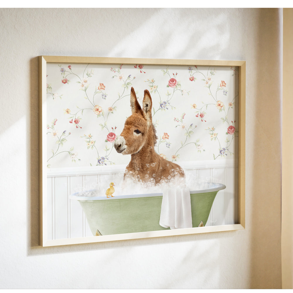 A donkey is sitting in a green bathtub filled with bubbles, with a yellow duck nearby, against a floral wallpaper background.