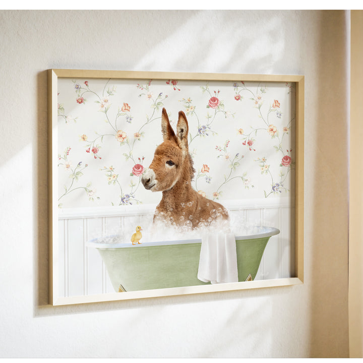 A donkey is sitting in a green bathtub filled with bubbles, with a yellow duck nearby, against a floral wallpaper background.