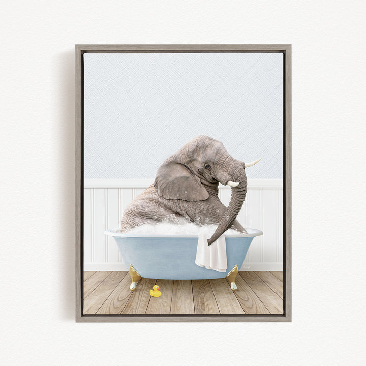 A gray elephant sitting in a blue bathtub filled with water, surrounded by yellow rubber duckies.