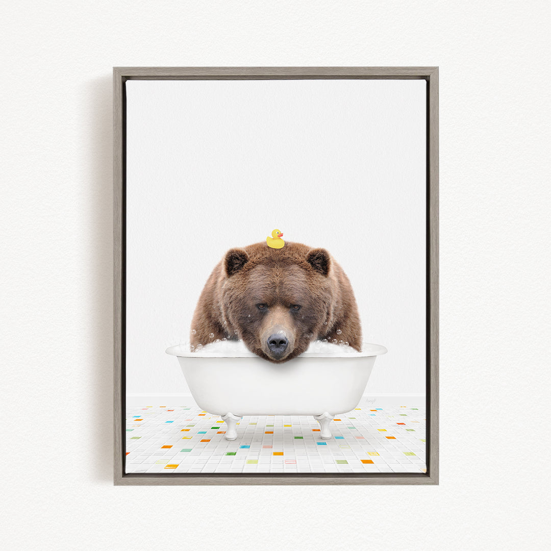 A brown bear is sitting in a white bathtub, with a yellow rubber duck perched on its head.