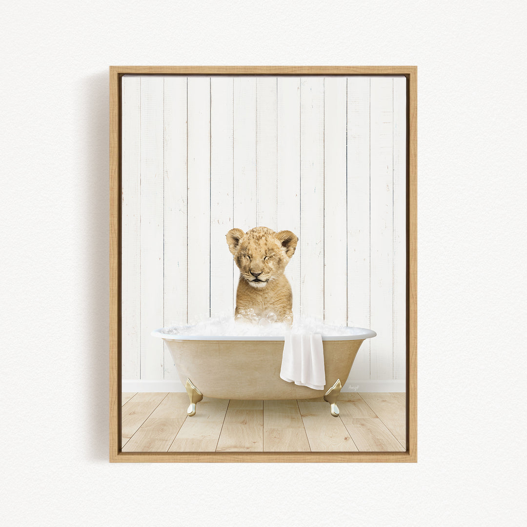 A young lion cub sitting in a bathtub filled with water, looking at the camera with a playful expression.