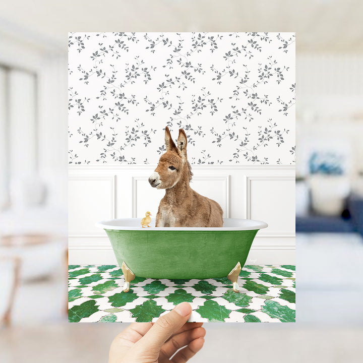 a hand holding a card with a dog in a bathtub