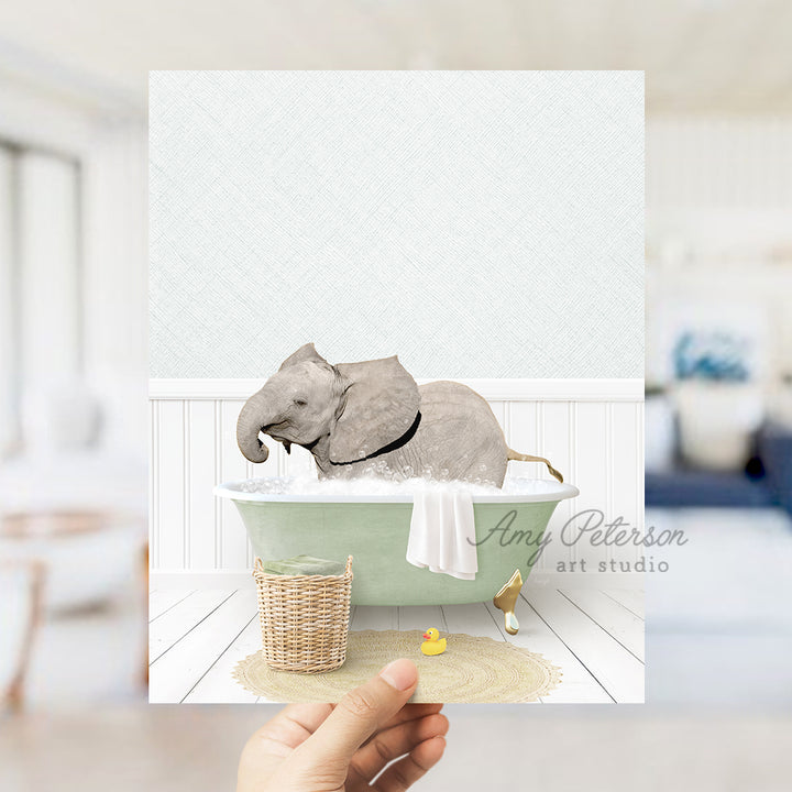 a person holding up a card with an elephant in a bathtub