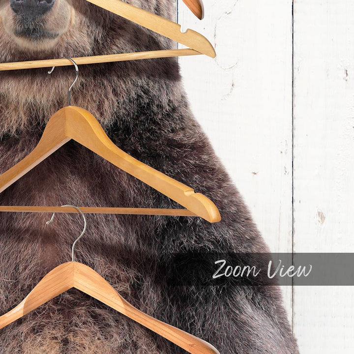 A close-up of a bear's head and neck, with several wooden hangers hanging from it.