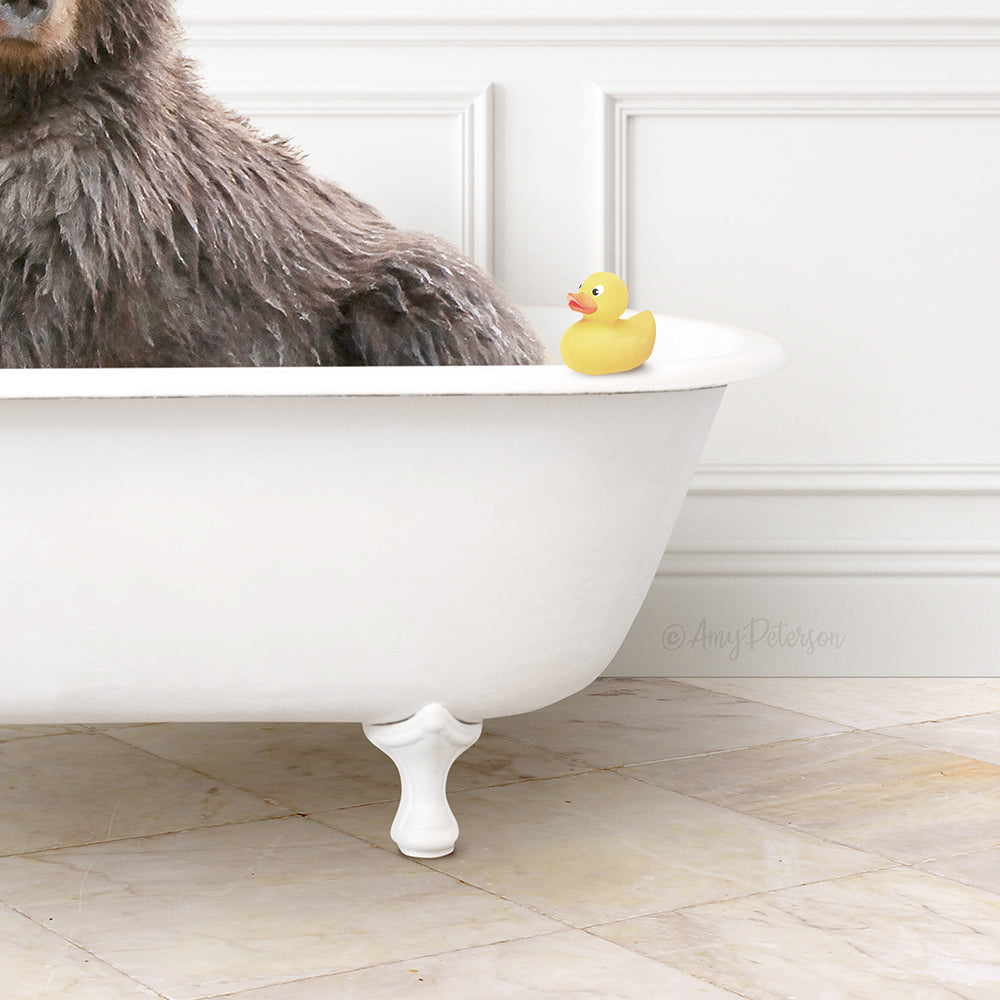 A large brown bear sits in a white bathtub, with a yellow rubber duck resting on the edge of the tub.