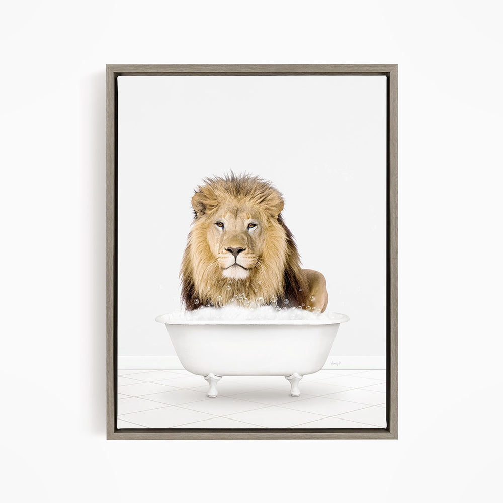 A lion sitting in a white bathtub filled with bubbles.