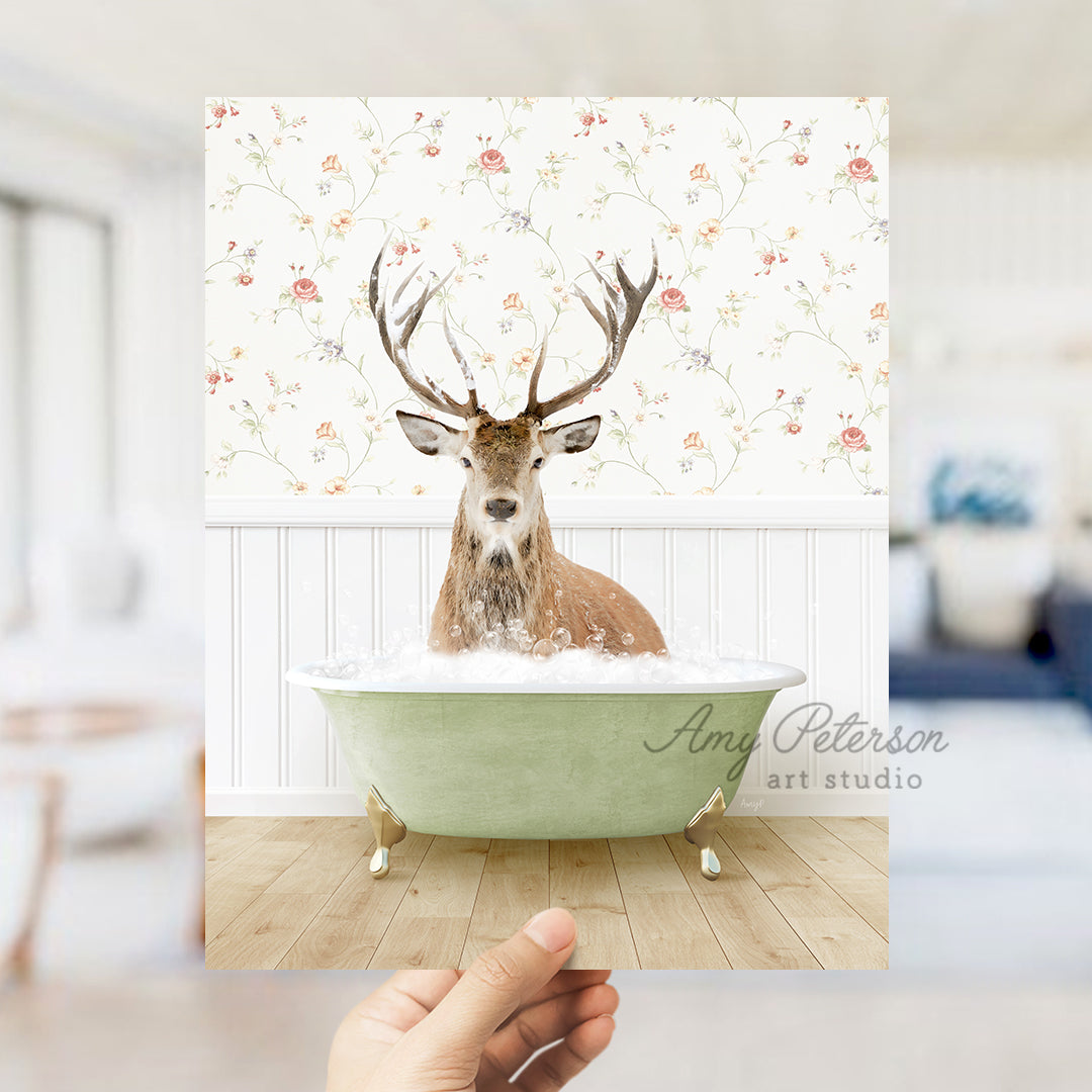 a hand holding a photo of a deer in a bathtub