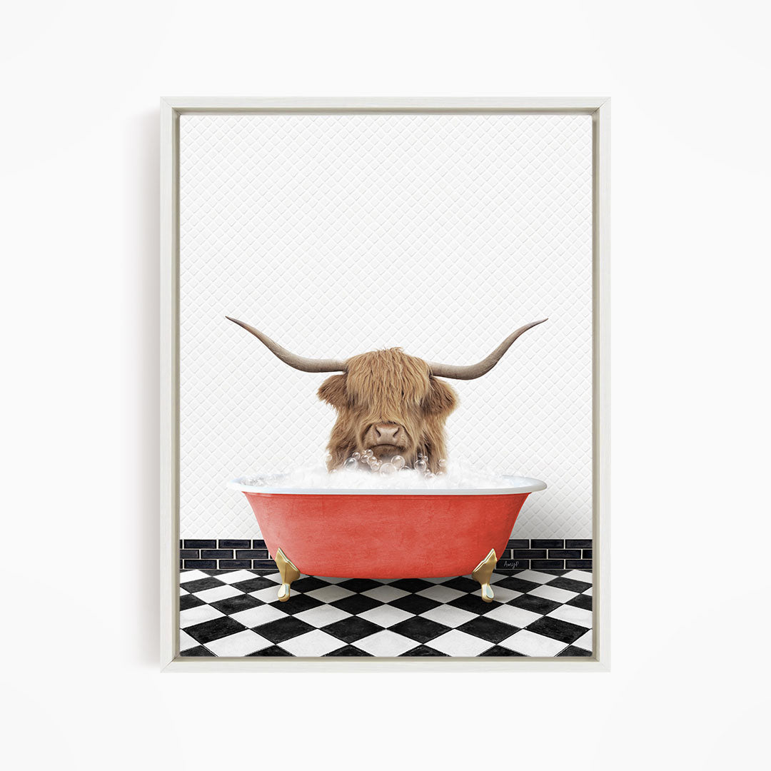 A Highland cow with large horns is sitting in a red bathtub filled with water, creating a whimsical and playful scene.