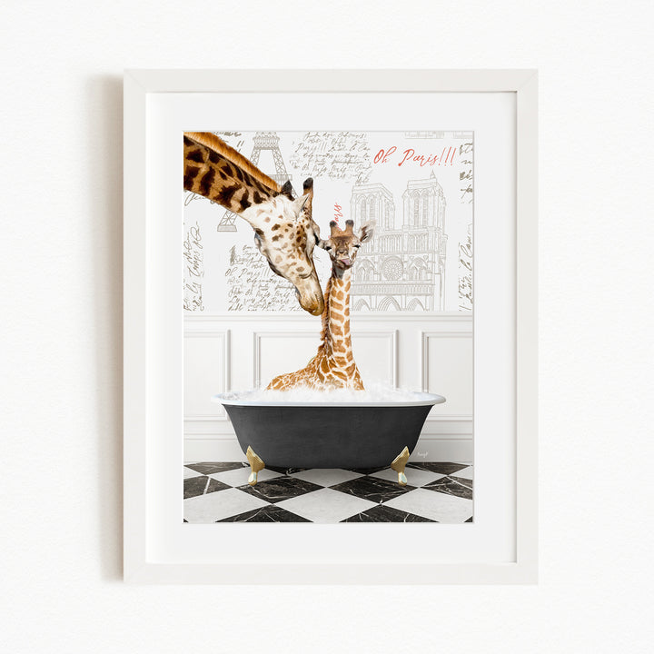 A framed image depicting two giraffes in a bathtub, with one giraffe appearing to be bathing the other. The background features a drawing of a building and the text "Oh Paris!!".