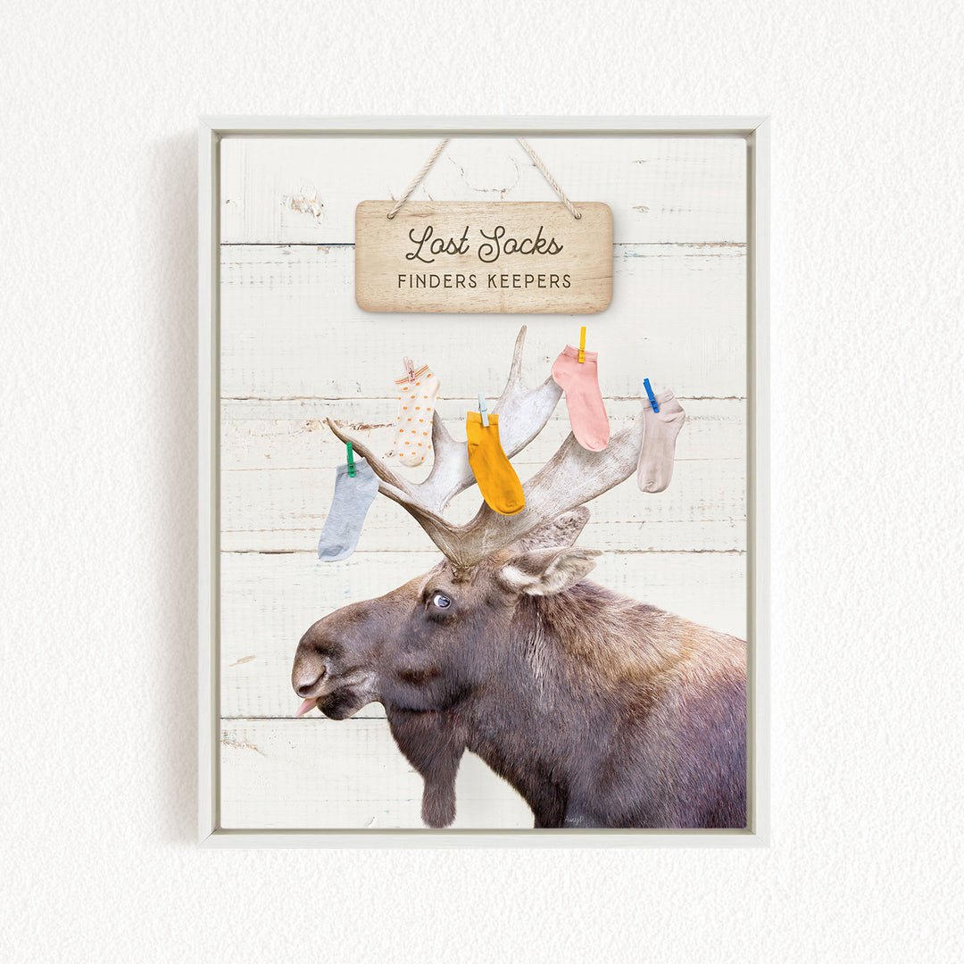 A moose with a sign that says "Lost Socks Finders Keepers" hanging above it.