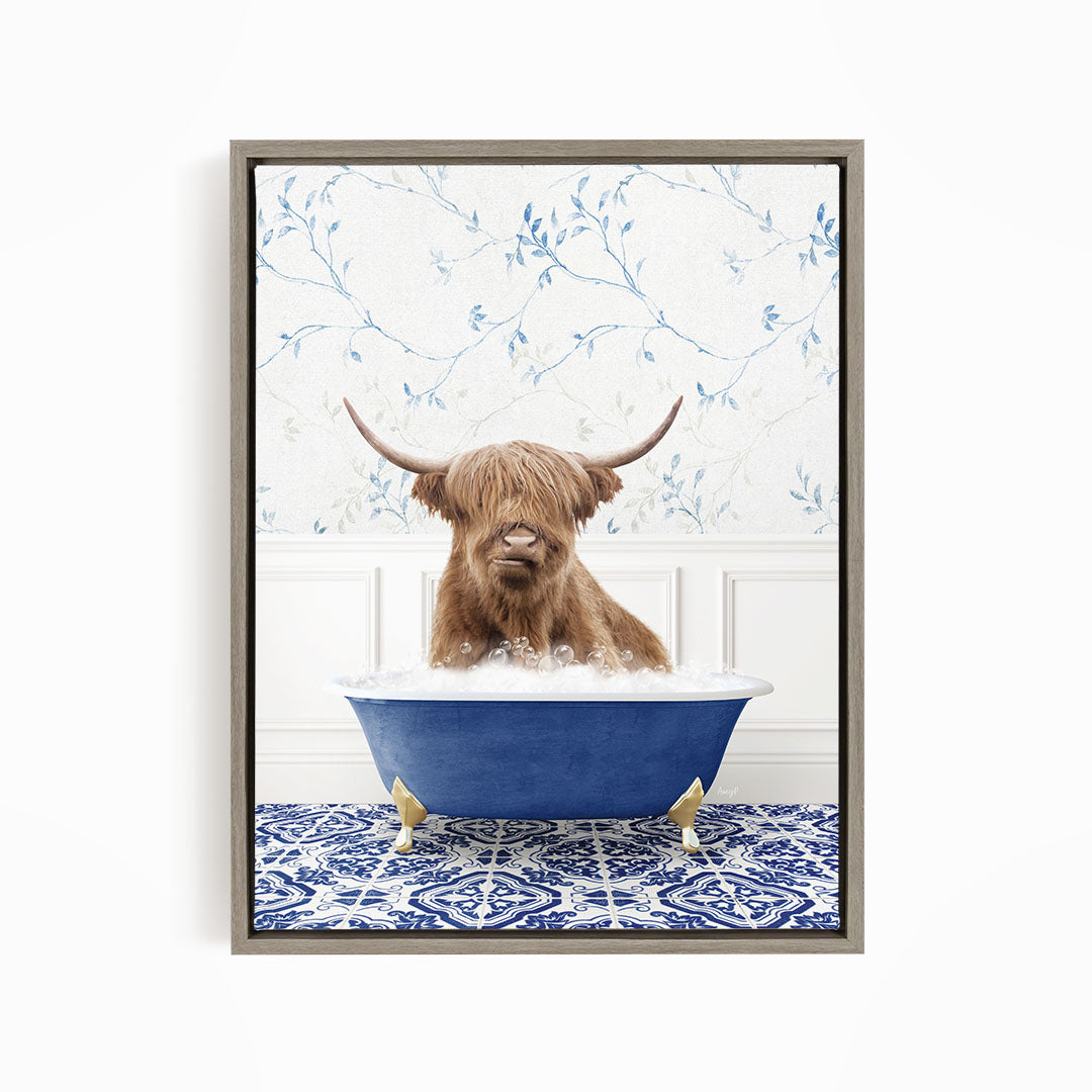A brown cow with long horns is sitting in a blue bathtub filled with water, surrounded by a blue and white patterned rug.