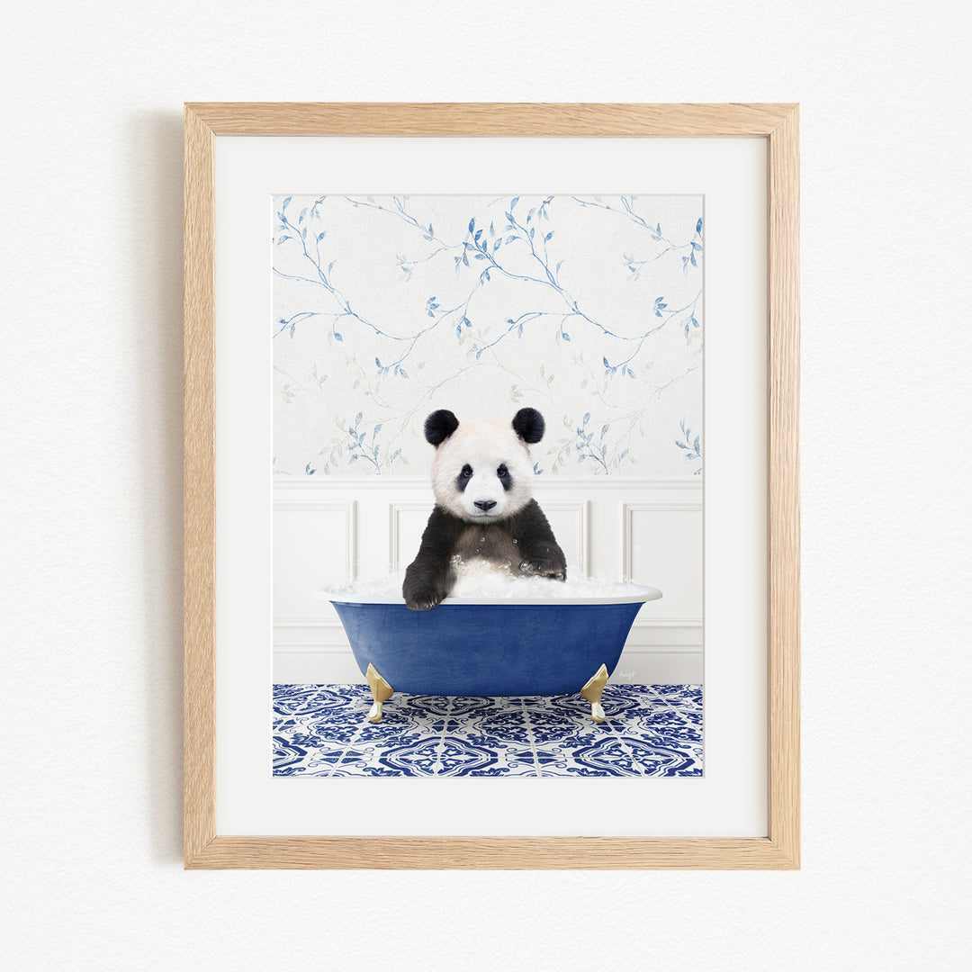 A panda bear sitting in a blue bathtub, surrounded by a blue and white floral patterned wall.