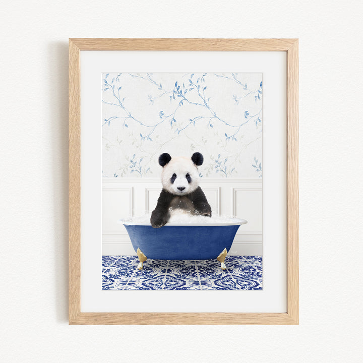 A panda bear sitting in a blue bathtub, surrounded by a blue and white floral patterned wall.