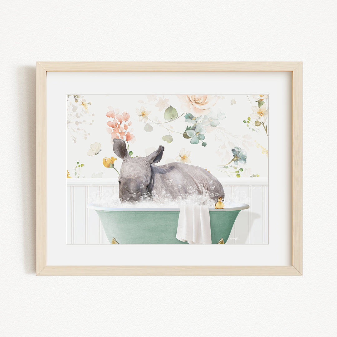 A rhinoceros is sitting in a green bathtub filled with water, surrounded by flowers and greenery.