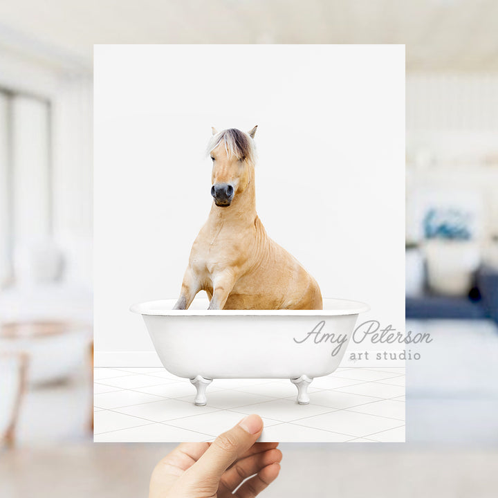 a hand holding a card with a horse in a bathtub