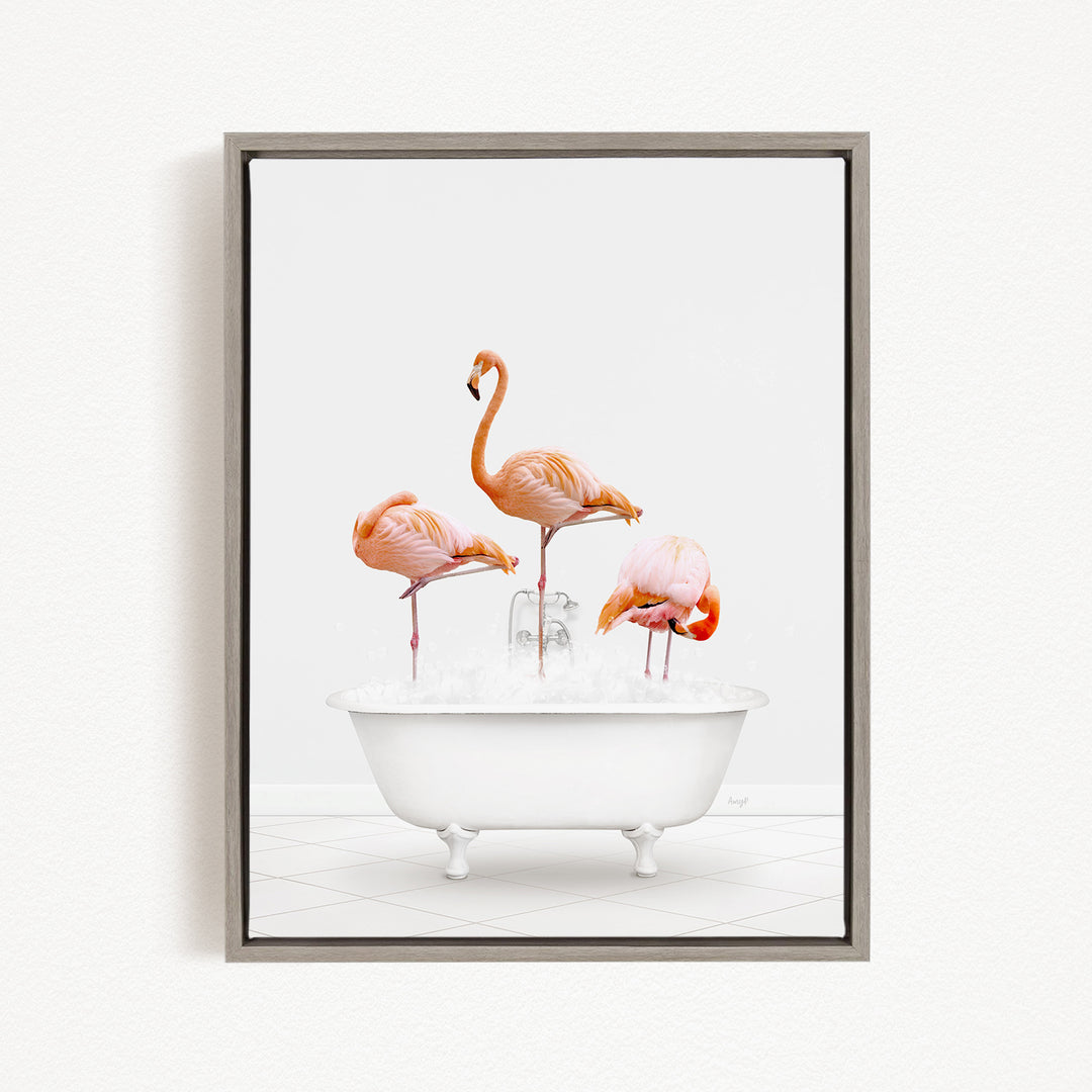A framed image depicting three flamingos standing in a white bathtub filled with water.