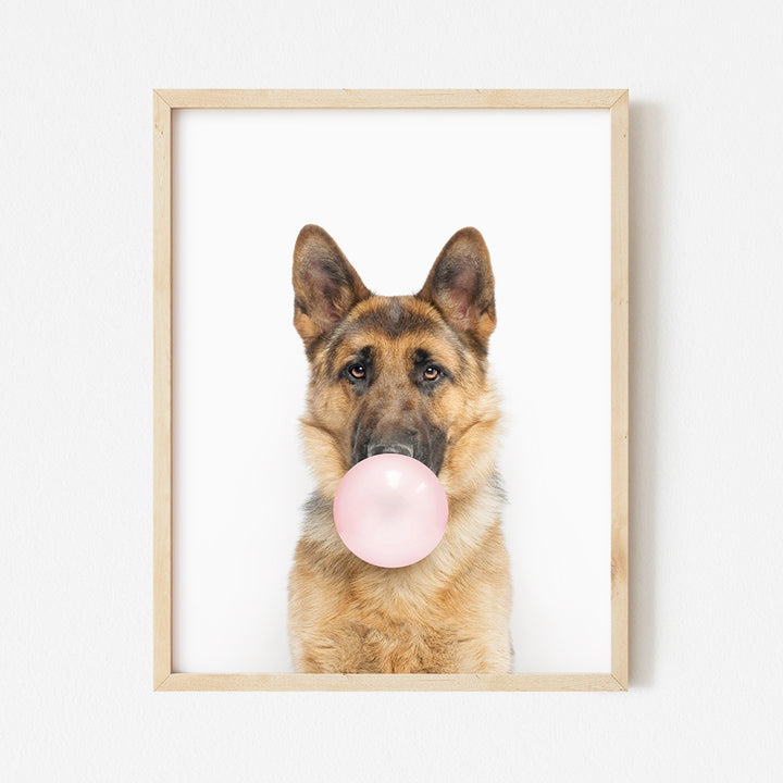 a dog with a pink bubble in its mouth