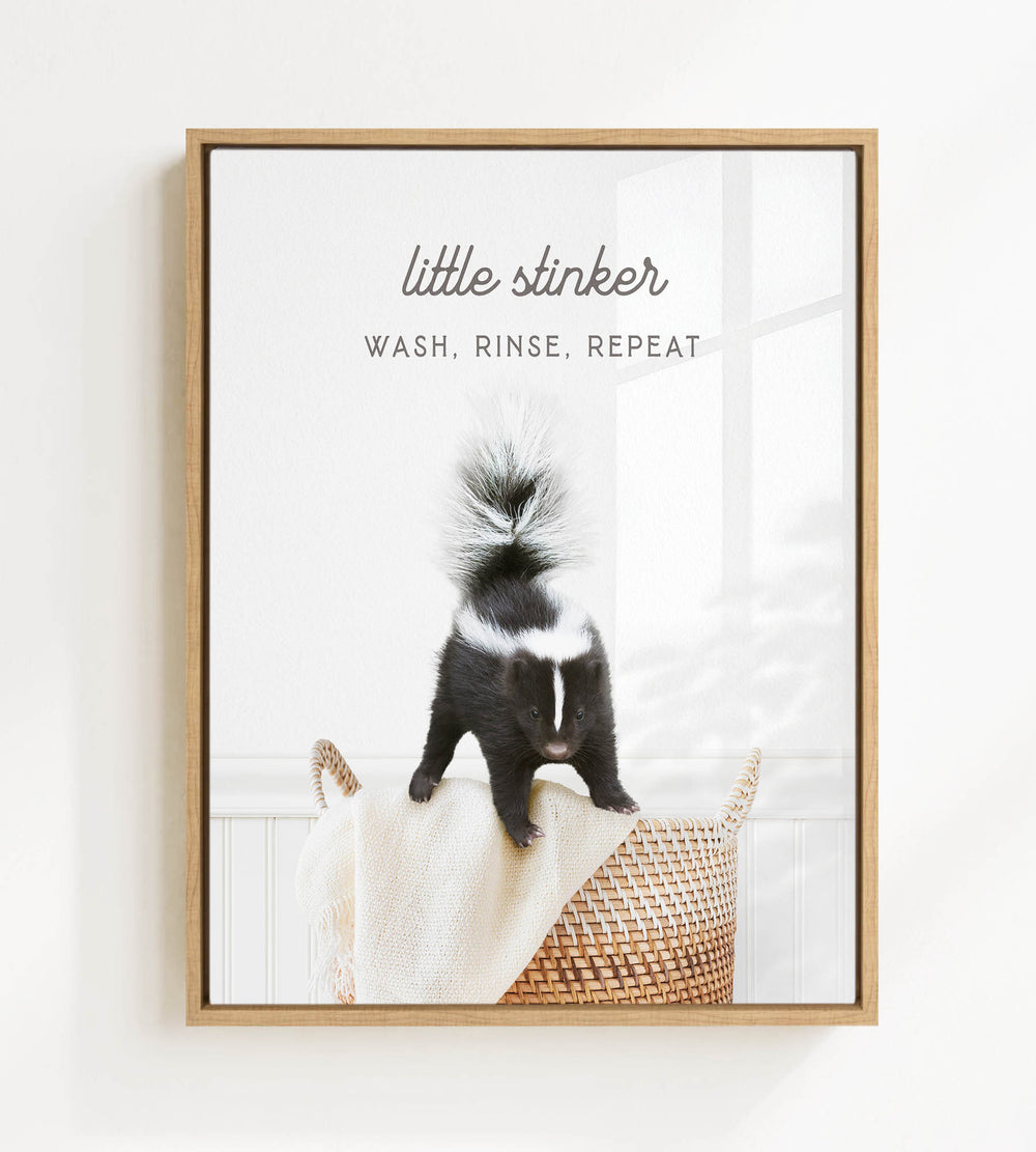 A black and white skunk standing on a woven basket in a bathroom.
