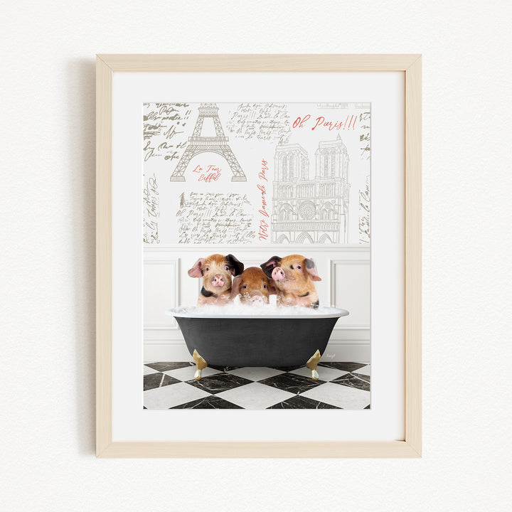 A framed image depicting three adorable pigs sitting in a bathtub, with a Paris-themed background featuring the Eiffel Tower and other Parisian landmarks.