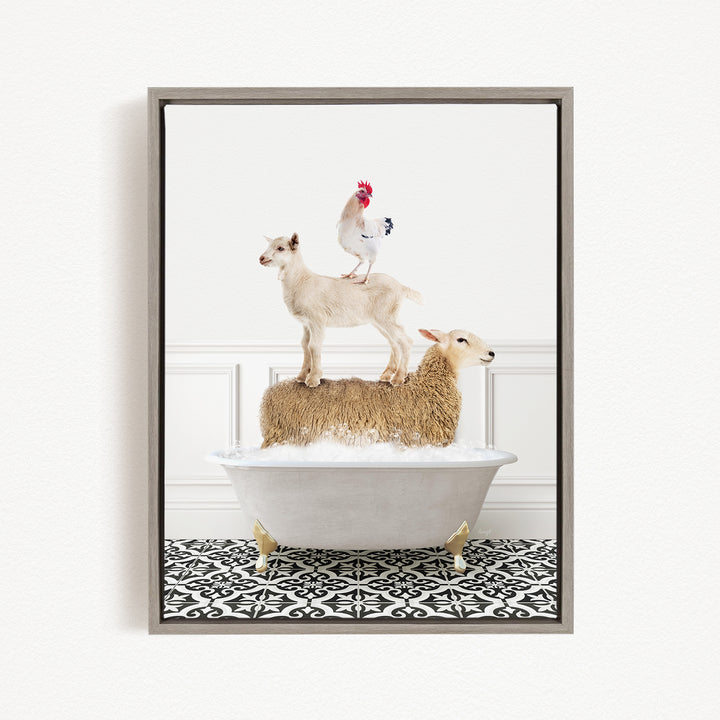 A framed image depicting a goat standing on top of a sheep in a bathtub, with a rooster perched on the sheep's back.