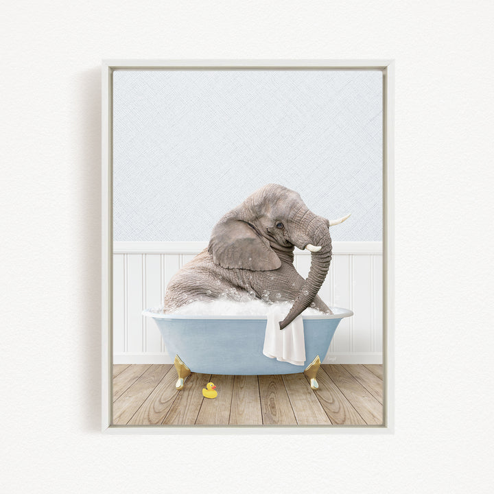 A gray elephant is sitting in a blue bathtub filled with water, surrounded by rubber ducks.