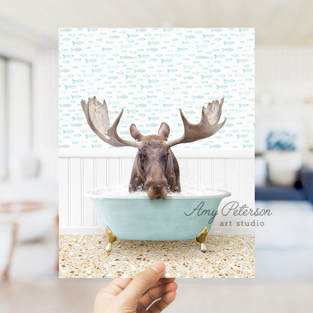 a hand holding up a card with a moose in a bathtub