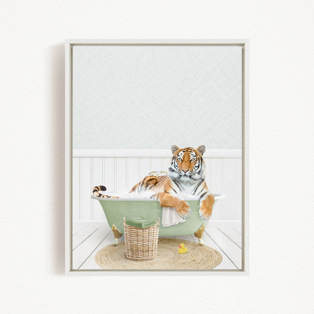 A tiger is sitting in a green bathtub, surrounded by a basket, a rubber duck, and a white wall.