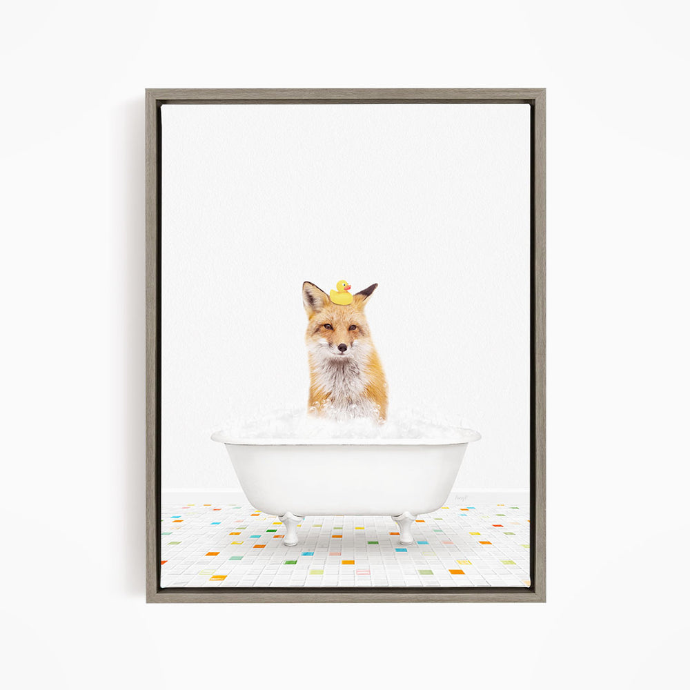A fox is sitting in a white bathtub filled with bubbles, with a rubber duck perched on its head.