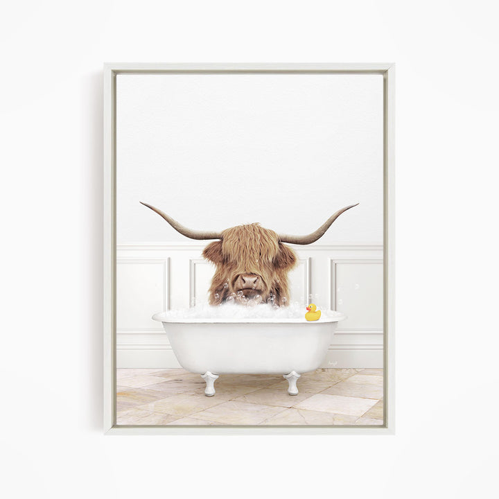 A long-haired cow with large horns is sitting in a white bathtub, surrounded by a white wall and a tiled floor.