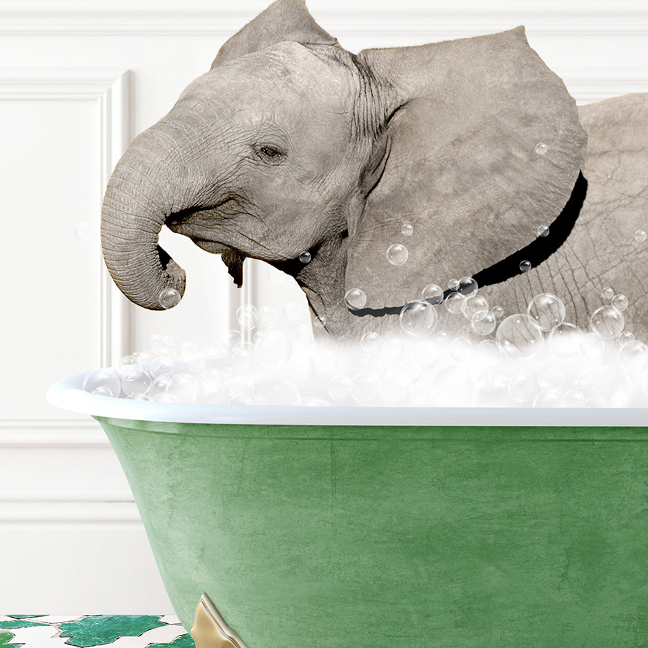 an elephant taking a bath in a green tub