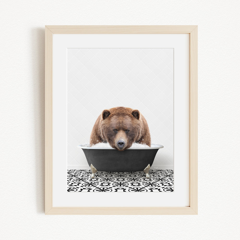 A brown bear is sitting in a black bathtub filled with water, appearing to be enjoying a relaxing bath.