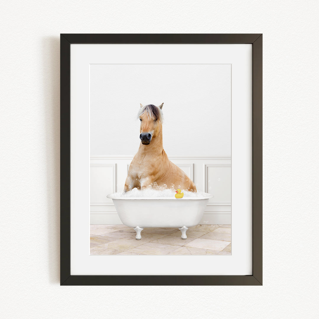 A brown horse sitting in a white bathtub filled with water, with a yellow rubber duck floating in the water.