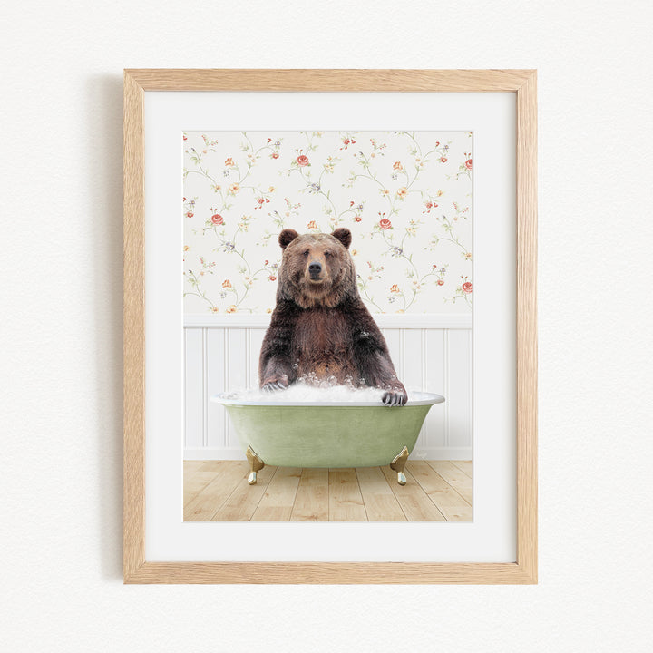A brown bear sitting in a green bathtub, surrounded by a floral patterned wall.