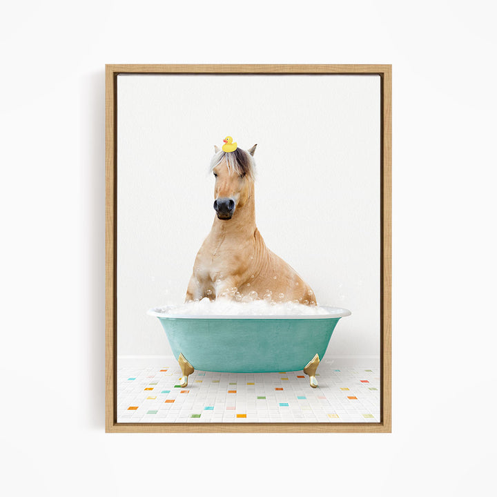 A light brown horse is sitting in a blue bathtub filled with bubbles, with a yellow rubber duck perched on its head.