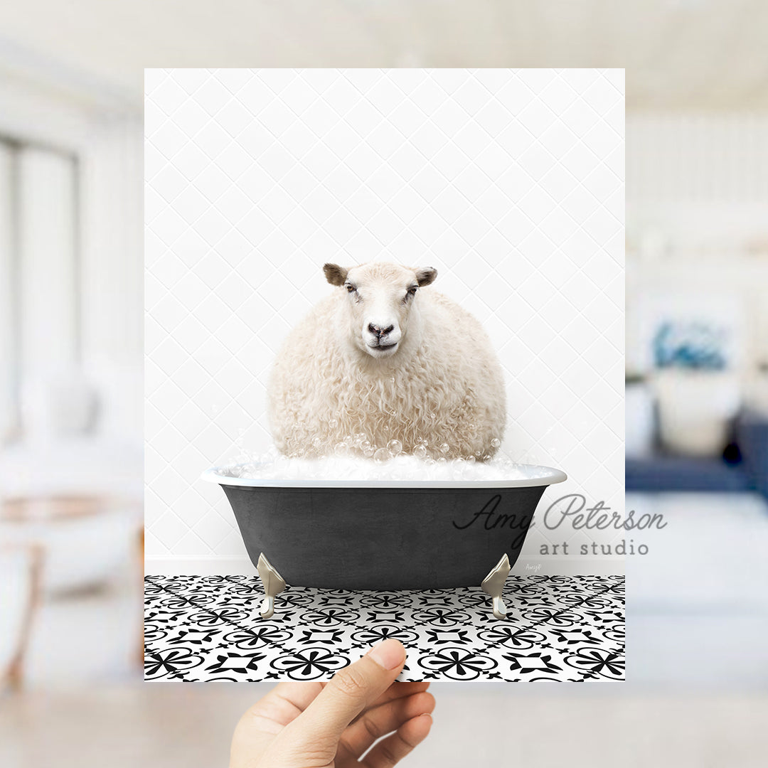 a hand holding a card with a sheep in a bathtub