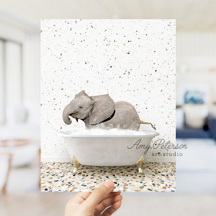 a hand holding up a card with an elephant in a bathtub