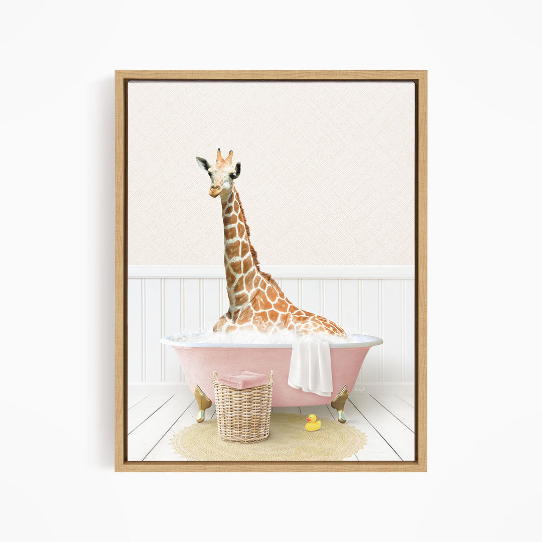 A giraffe sitting in a pink bathtub filled with water, surrounded by a basket of toys and a yellow rubber duck.