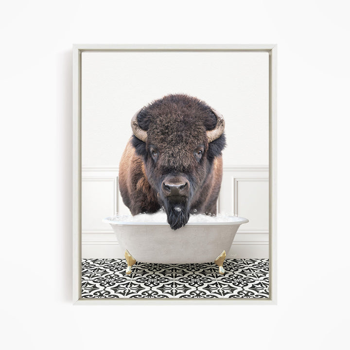 A buffalo with a long beard is standing in a white bathtub, with a black and white patterned floor beneath it.