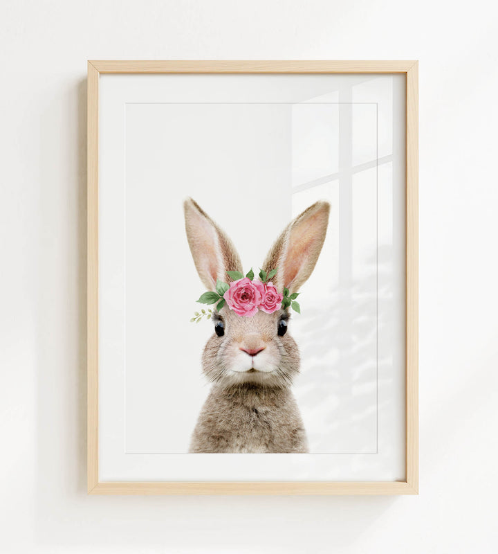 A framed image of a rabbit wearing a pink flower crown.