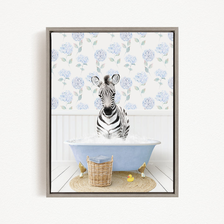 A zebra sitting in a blue bathtub filled with water, surrounded by a wicker basket and a rubber duck.