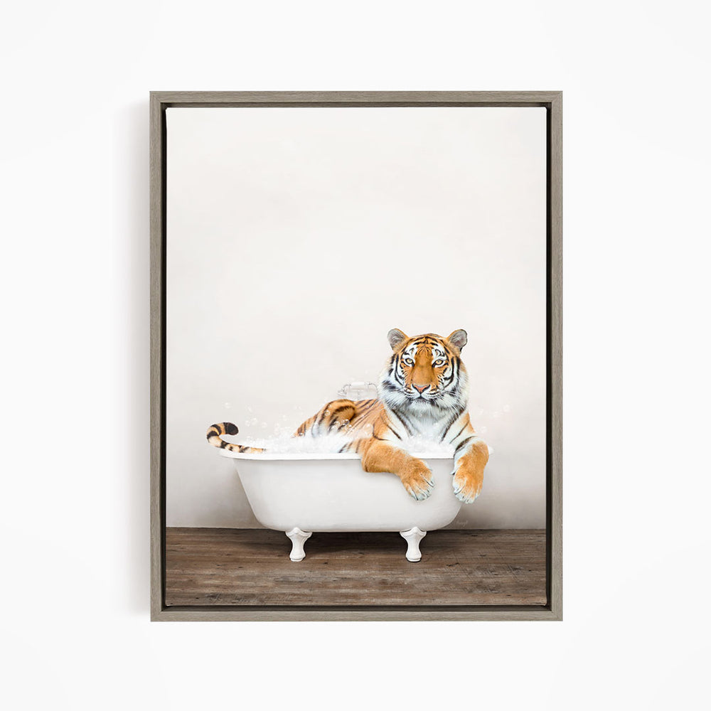 A tiger is sitting in a white bathtub, appearing relaxed and enjoying the bath.